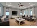 Inviting living room features large windows, hardwood floors, and a neutral color palette, creating a comfortable atmosphere at 8724 Ocean Tides Cv, Parrish, FL 34219