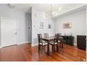 Minimalist dining room with wooden floors, sleek furniture, and a modern chandelier at 111 N 12Th St # 1815, Tampa, FL 33602