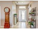 The welcoming home foyer boasts a grand grandfather clock, lovely decor, and lots of natural light at 11424 Drifting Leaf Dr, Riverview, FL 33579