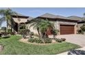 Manicured front yard with decorative brick walkway and lush, mature landscaping at 11424 Drifting Leaf Dr, Riverview, FL 33579