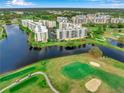 A lovely aerial view of condo community on a golf course with lush landscaping and waterways at 1200 Country Club Dr # 2206, Largo, FL 33771