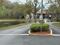 Neighborhood street with a pond and water feature fountain in the background at 12155 Environmental Dr # 6, New Port Richey, FL 34654