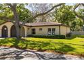 Inviting single-story home featuring a tile roof, lush landscaping, and attached garage at 12200 Vonn Rd # 6D, Largo, FL 33774