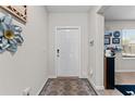 Welcoming entryway with neutral walls, decorative accents, and a patterned rug at 14618 Scottburgh Glen Dr, Wimauma, FL 33598