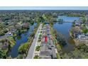 Aerial view of townhomes nestled by scenic lakes, lush trees, and a well-maintained neighborhood, creating a serene environment at 2270 Spring Lake Ct, Clearwater, FL 33763