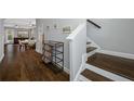 Warm entryway featuring wood floors, a staircase with wood treads, and an open view to the dining and living areas at 2270 Spring Lake Ct, Clearwater, FL 33763