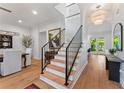 Bright foyer featuring an elegant staircase, chandelier and hardwood flooring with entry to the formal dining room at 2633 N Dundee St, Tampa, FL 33629