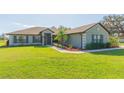 Charming single-story home with a well-manicured lawn and inviting curb appeal at 27941 Austin Woods Dr, Dade City, FL 33525