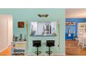 Charming bar area with stools and tiki decor, perfect for entertaining at 300 Promenade Dr # 106, Dunedin, FL 34698