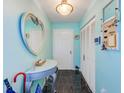 Bright entryway with unique decor, tiled floor, and ample storage space at 300 Promenade Dr # 106, Dunedin, FL 34698