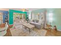 Comfortable living area with bright walls, plush seating, and a view of the outdoors at 300 Promenade Dr # 106, Dunedin, FL 34698