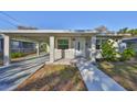 Attractive home exterior featuring a convenient covered carport and well-manicured landscaping at 3218 N 16Th St, Tampa, FL 33605