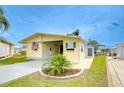 Delightful yellow home with tidy lawn, mature landscaping, and convenient proximity to sidewalks at 35246 Tiffani Ct, Zephyrhills, FL 33541