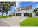 Spacious garage with three bays and a brick paved driveway, surrounded by well-maintained landscaping at 3801 Bayshore Blvd, Tampa, FL 33611