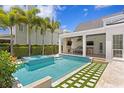 Backyard oasis with a modern pool, spa, outdoor kitchen, and entertainment area at 3801 Bayshore Blvd, Tampa, FL 33611