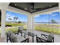Covered porch with seating area offering scenic views of the water and skyline at 3801 Bayshore Blvd, Tampa, FL 33611