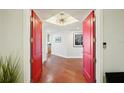Elegant entrance featuring red double doors and hardwood floors leading to a stylish foyer at 400 Beach Ne Dr # 1202, St Petersburg, FL 33701