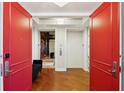 Grand entrance with striking red doors leading to elevators and a seating area at 400 Beach Ne Dr # 1202, St Petersburg, FL 33701