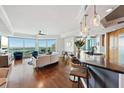 Bright living room with hardwood floors, open floor plan, bar seating, and beautiful views at 400 Beach Ne Dr # 1202, St Petersburg, FL 33701