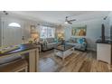Cozy living room, with a ceiling fan, two sofas, table, and front door at 4103 Gulf Blvd # 205, St Pete Beach, FL 33706