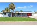 Inviting home with a brick exterior, solar panels, and a well-maintained lawn at 4301 50Th S Ter, St Petersburg, FL 33711