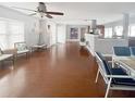 Open concept living area with wood flooring, a ceiling fan, and a view to the kitchen at 4301 50Th S Ter, St Petersburg, FL 33711