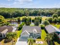 Aerial view showcasing the single-Gathering home's location near lush green space and a tranquil waterway at 4320 Northampton Dr, New Port Richey, FL 34653
