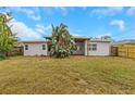 Spacious backyard featuring a covered patio and lush landscaping, perfect for outdoor enjoyment at 5813 18Th S Ave, Gulfport, FL 33707