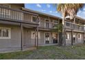 Condominium exterior featuring two-story units with private balconies and well-maintained grounds at 6330 Newtown Cir # 30B4, Tampa, FL 33615