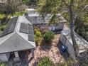 Aerial view of property featuring solar panels, shed, and mature trees at 7101 8Th N Ave, St Petersburg, FL 33710