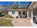 Inviting front entrance with a wreath on the door, a brick path and a carport for parking at 7101 8Th N Ave, St Petersburg, FL 33710