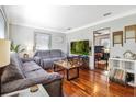 Comfortable living room featuring hardwood floors, two couches, and a view to other rooms at 7101 8Th N Ave, St Petersburg, FL 33710