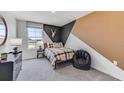 Modern bedroom featuring black and brown accents, a window view, and soft carpet at 10590 Dusty Boot Rd, Land O Lakes, FL 34638