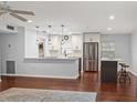 Bright, modern kitchen with white cabinetry, stainless steel appliances, and a functional island for meal preparation at 1719 Belleair Forest Dr # B, Belleair, FL 33756