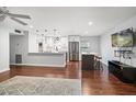 Open concept living area with modern finishes, hardwood floors, and stainless steel appliances in the adjacent kitchen at 1719 Belleair Forest Dr # B, Belleair, FL 33756
