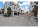 Modern condo exterior with private garages and concrete driveway, set against a blue sky at 1910 W North A St # 5, Tampa, FL 33606