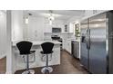 Bright kitchen featuring stainless steel appliances, an island with seating, and modern white cabinetry at 2710 W Osborne Ave # 1, Tampa, FL 33614