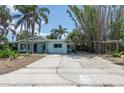 Charming single-story home with mature trees and a concrete driveway at 300 Westwinds Dr, Palm Harbor, FL 34683