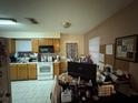 Functional kitchen with a microwave, oven, cabinets, tile floors, and a window that provides natural light at 3111 W Spruce St, Tampa, FL 33607