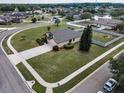 Overhead shot of a landscaped house surrounded by a green lawn and neighborhood streets at 3303 Ranchdale Dr, Plant City, FL 33566