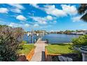 Waterfront property featuring a private dock with views of the serene waterway and lush landscaping at 3906 Versailles Dr, Tampa, FL 33634