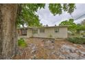 Inviting single-story house with covered parking, manicured lawn, and lush greenery in a quiet neighborhood at 434 Pevetty Dr, Plant City, FL 33563