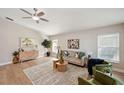 Bright living room featuring modern furnishings, wood floors, neutral walls, and plenty of natural light at 4932 Wellbrook Dr, New Port Richey, FL 34653