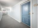 Hallway leading to unit featuring light blue walls and grey carpet at 5220 Brittany S Dr # 1108, St Petersburg, FL 33715