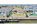 A waterfront backyard with a fence, pool, and a private dock, ideal for relaxation and outdoor entertaining at 5709 Sea Turtle Pl, Apollo Beach, FL 33572