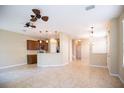 Spacious open-concept living area features tile flooring and opens to the kitchen with a breakfast bar at 5710 Kingletsound Pl, Lithia, FL 33547
