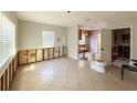 Spacious living room featuring tile flooring and exposed wall studs ready for renovation, offering customization potential at 6708 S Faul St, Tampa, FL 33616