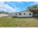 Spacious backyard with a patio, offering a great outdoor living space, and a partial fence at 6901 298Th N Ave, Clearwater, FL 33761