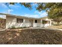 Welcoming single-story home with a brick accent, complemented by a beautifully maintained front yard at 6901 298Th N Ave, Clearwater, FL 33761