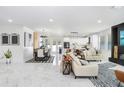 Spacious living room with marble floors, modern decor, an open layout to dining and kitchen at 7403 Edgemere Rd, Tampa, FL 33625